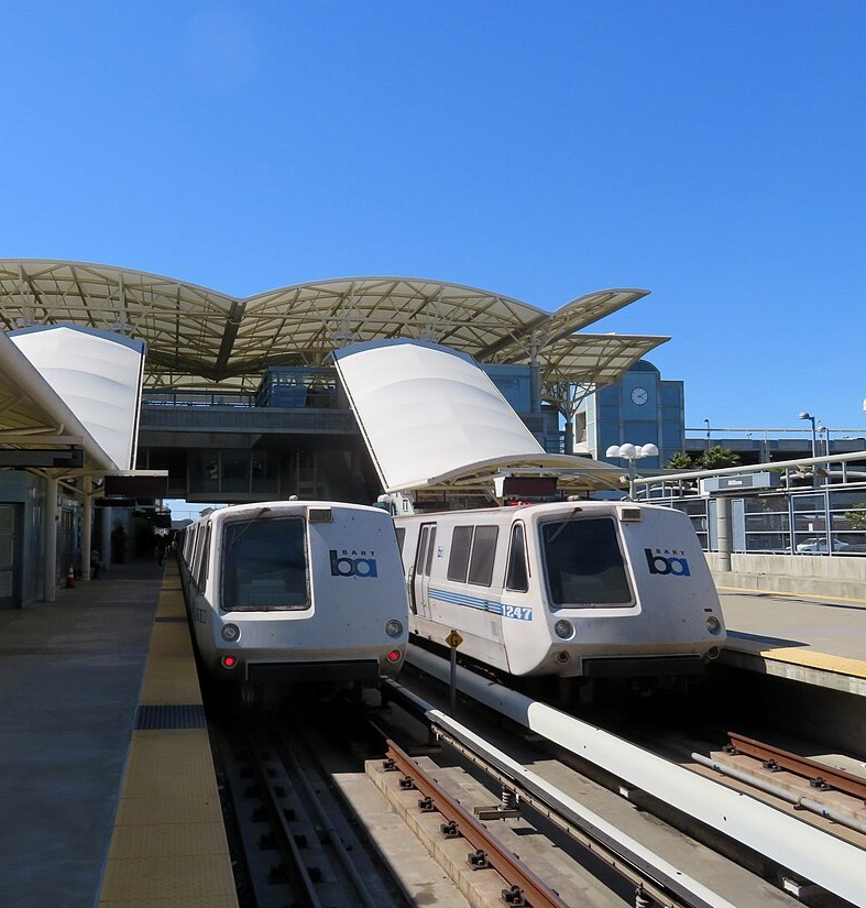 Two_BART_trains_at_Millbrae_station,_June_2018